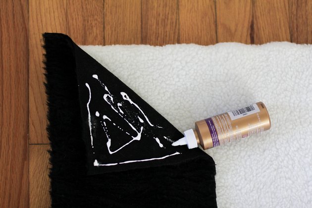 Gluing black shearling fabric to white shearling fabric