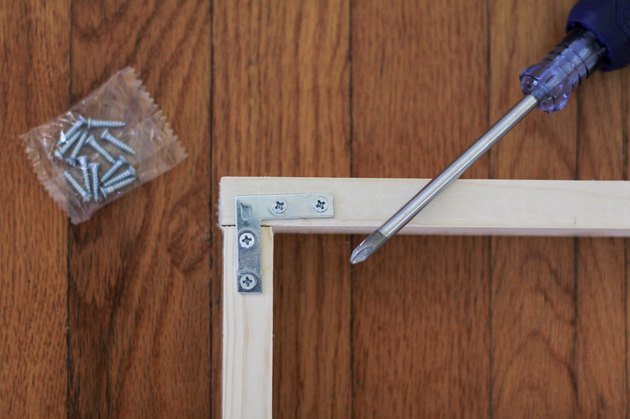 Corner of wood frame fastened with flat corner brace