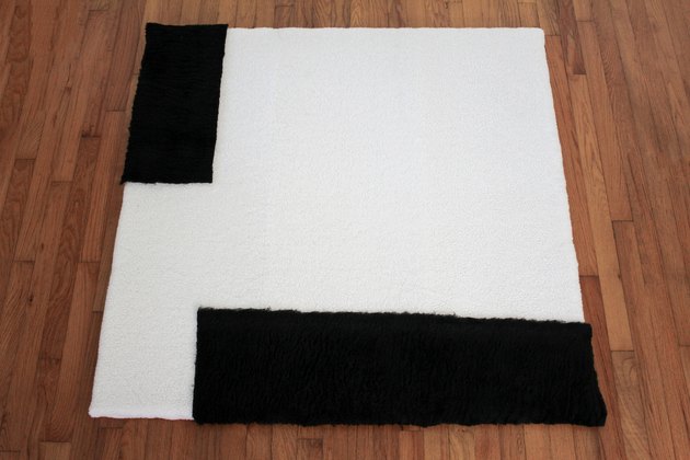 Placing black shearling fabric on top of white shearling