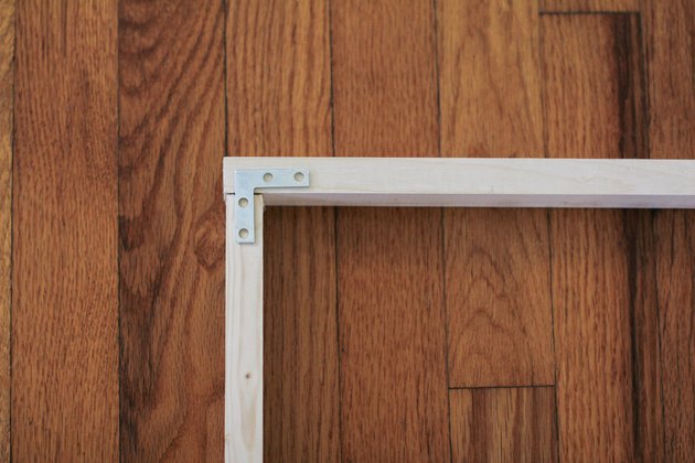Corner of wood frame fastened with flat corner brace