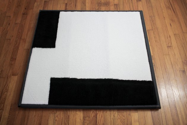 Fabric artwork placed inside painted wood frame