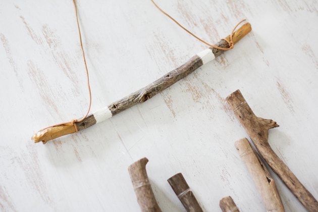 Leather cord tied to horizontal branch