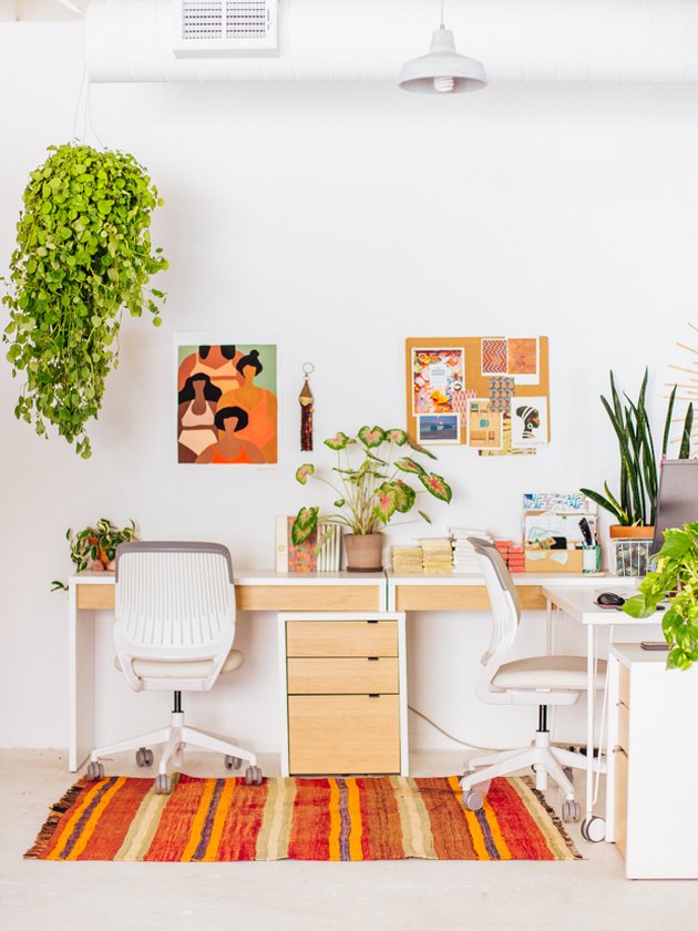 Boho office with warm colors, abstract artwork, and plants