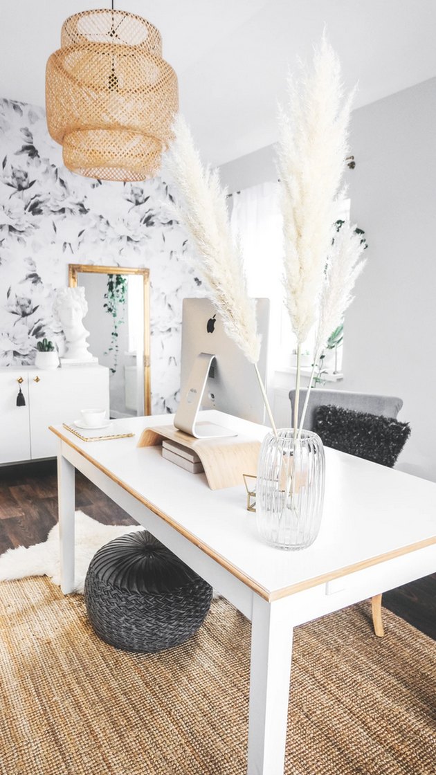 Boho office with pampas grass, white desk, and bamboo chandelier