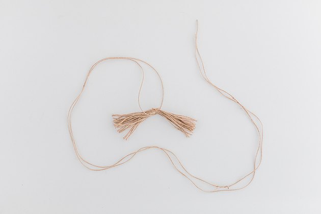 Before finishing the tassel, lay a piece of twine in the middle.