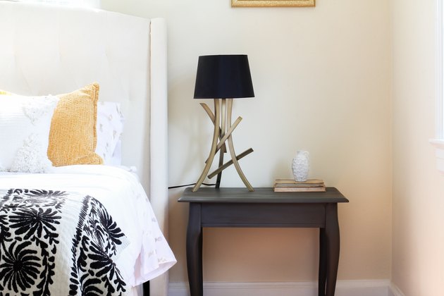 Chalk painted end table styled in bedroom