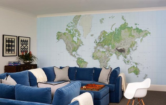 family room wall ideas with large map and blue u-shaped couch