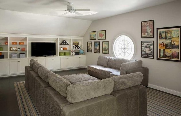 family room wall ideas with vintage posters and gray couch