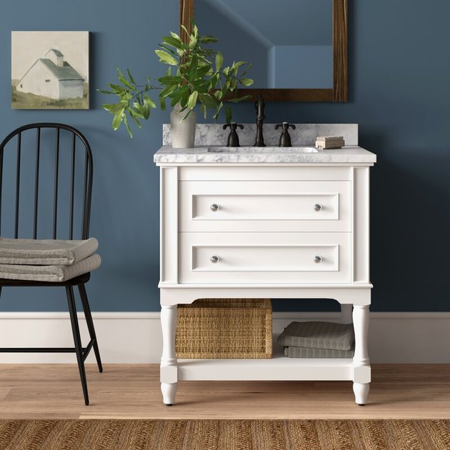 White country bathroom vanity with blue wall and barn painting