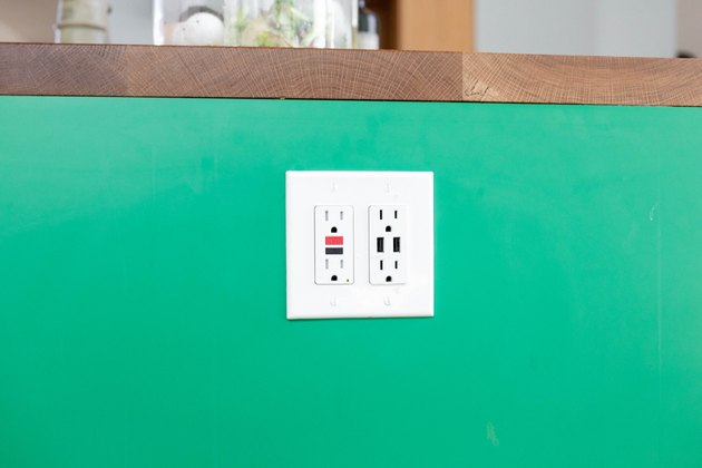 close up of kitchen electric outlet on green background