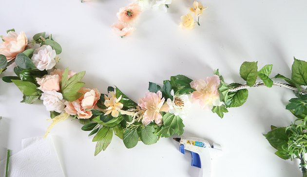 Gluing flowers to garland.