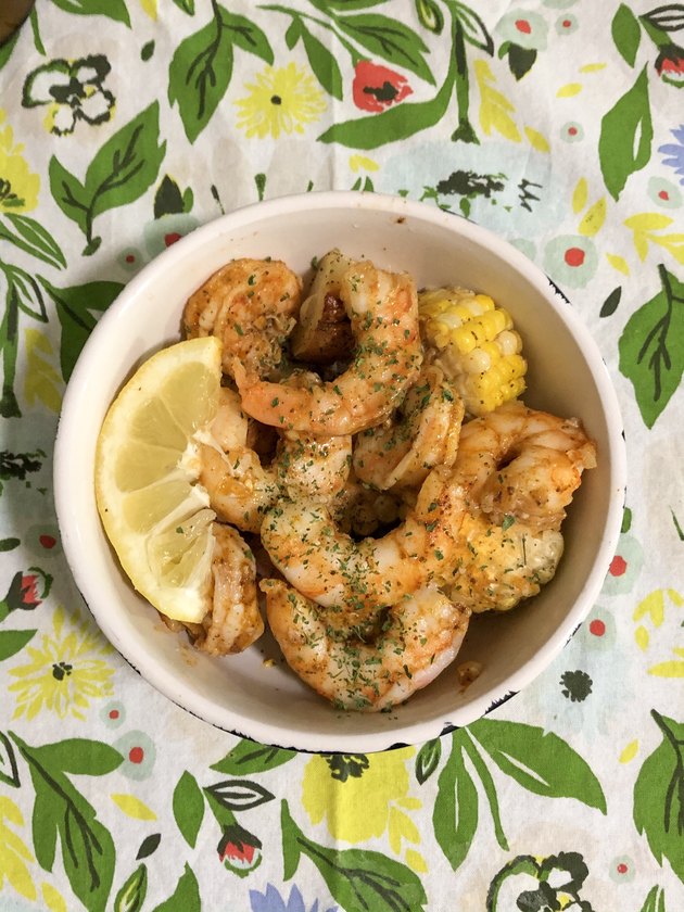 patterned tea towel with bowl with shrimp dish inside