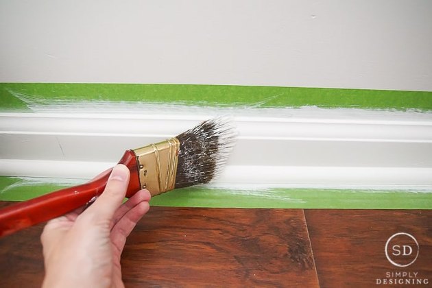 Baseboards being painted.
