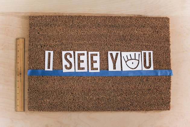Letter stencils centered on doormat