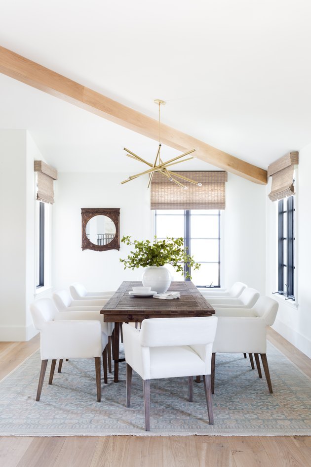 white neutral colors in dining room with exposed beams and bamboo roman shades