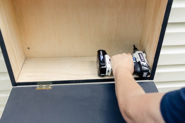 Drilling exterior screws into cabinet and wall with HART impact driver