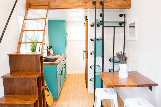 Interior shot of tiny cabin with teal accents.