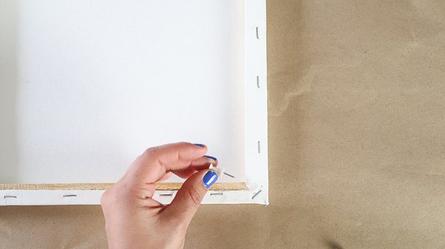 Place pushpins at each corner of canvas.
