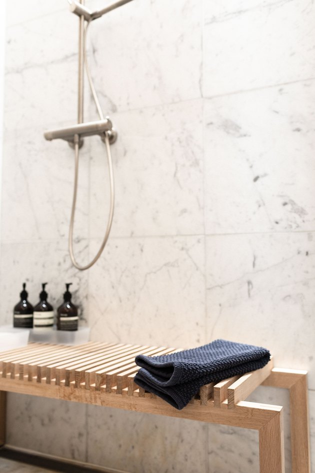 wooden bench in marble shower