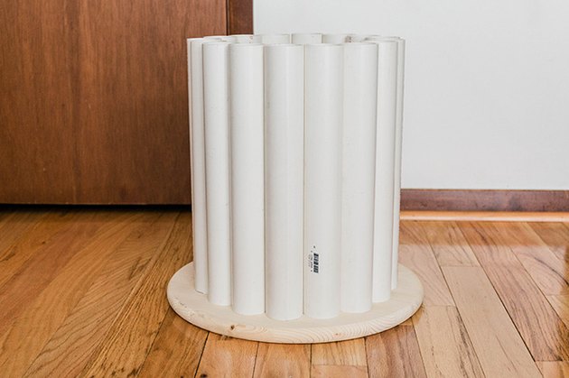 Lay the cut pipes out in a circle around the underside of the wood tabletop.