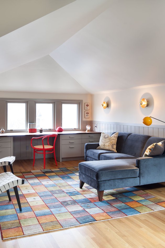 attic living room with built-in desk and colorful furnishings