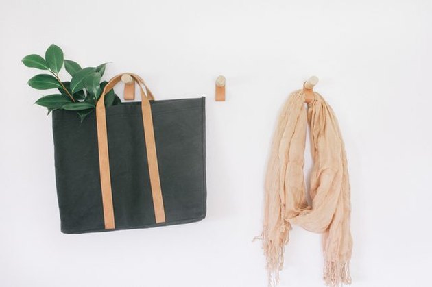 Leather and wood wall hooks offer multi-functional hanging