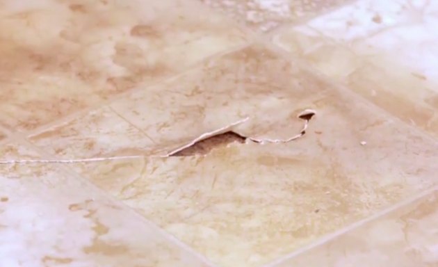 A damaged vinyl tile.