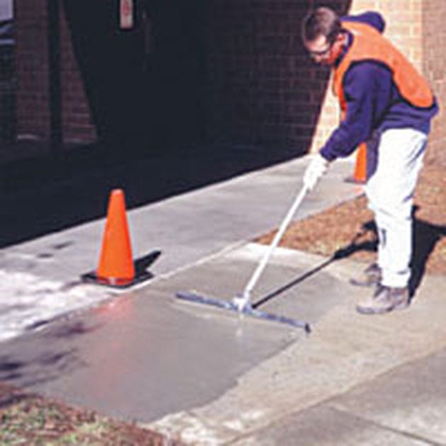 Applying concrete resurfacer.