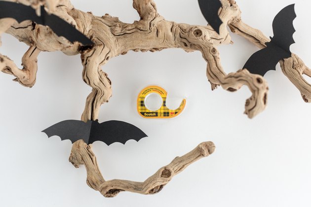 Tape the bats to the branch.