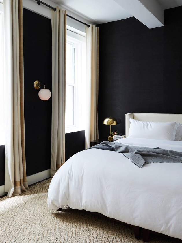 elegant bedroom with black walls and high ceilings
