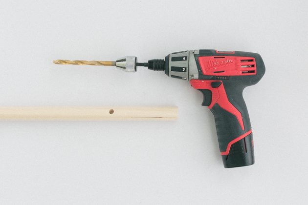 Drill through the mark with a cordless drill and drill bit.