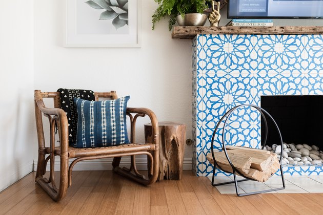 closeup of accent chair and accent fireplace with hardwood floors