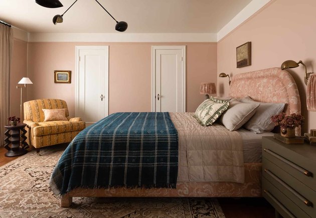 pink bedroom color idea with ochre chair and pink bed with navy throw
