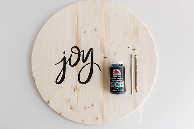 Paint the word "joy" on the face of your wooden circle.