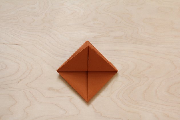 One bottom corner folded to top corner