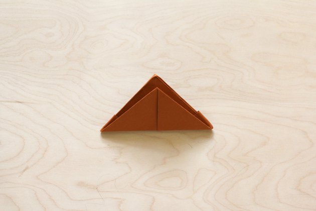 Second bottom corner folded to top corner