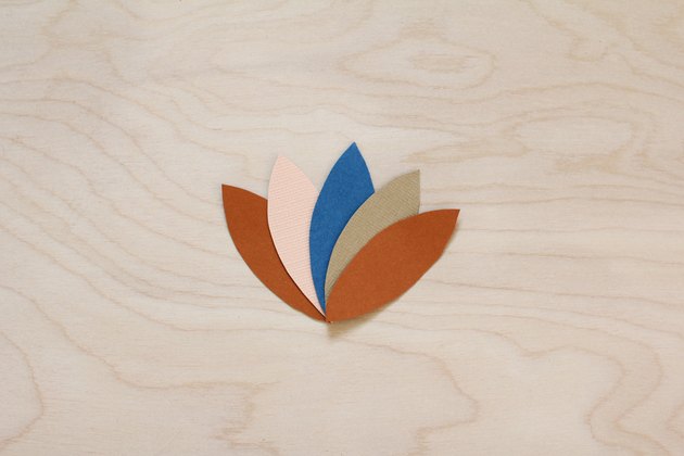 Five paper feathers glued together