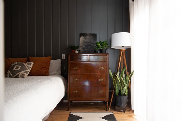 Bedroom with vintage decor and dark wall