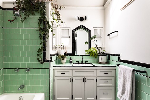 Green tile bathroom with plants