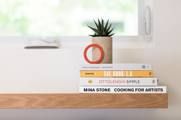 Kitchen shelf with cookbooks and plant