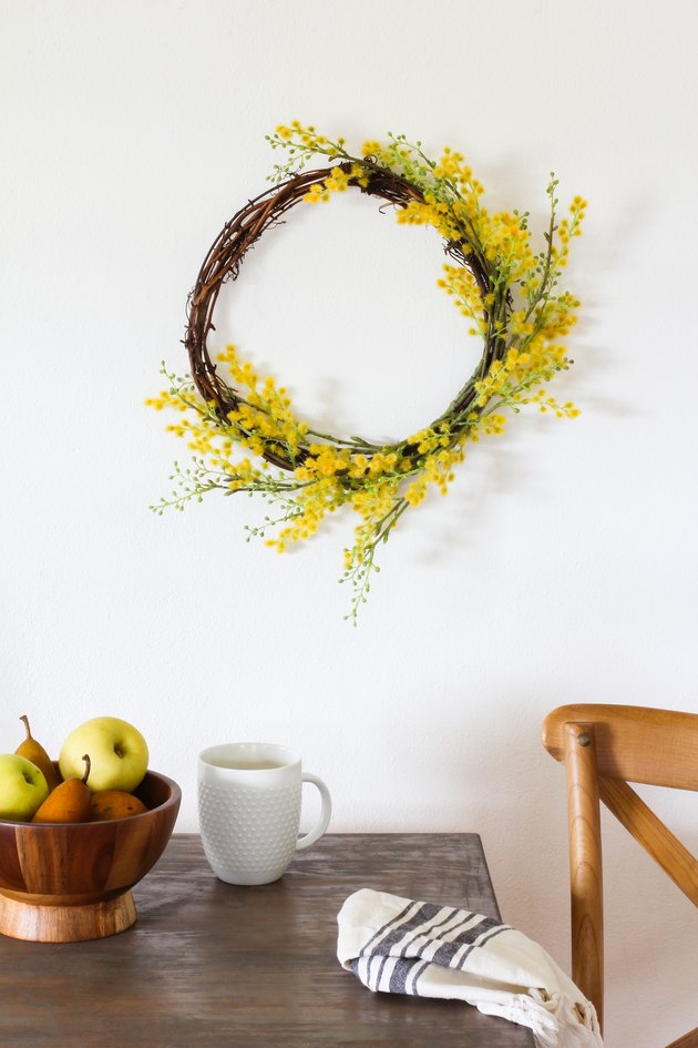 Target Decor: Yellow crespedia wreath hanging above table