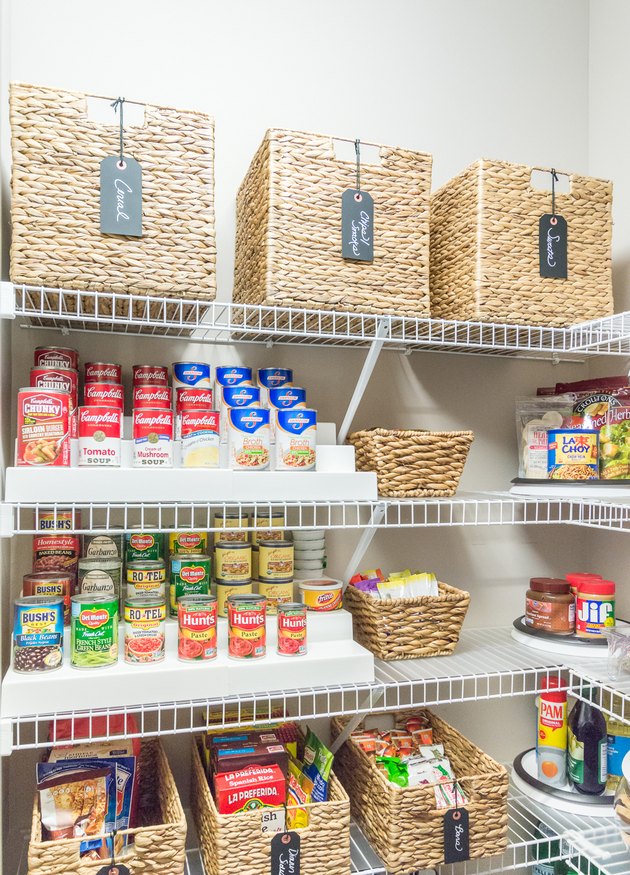 organized small pantry closet with woven bins