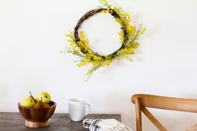 Target decor: Yellow crespedia wreath hanging above table