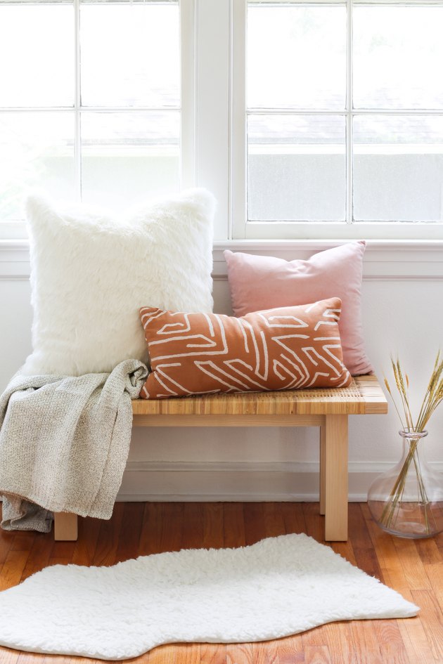 Target Decor: Three pillows and a sweater blanket on a bench