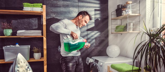 Man pouring laundry detergent