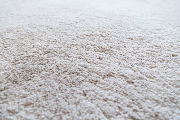 Close-up of a white shaggy carpet, shallow depth of field