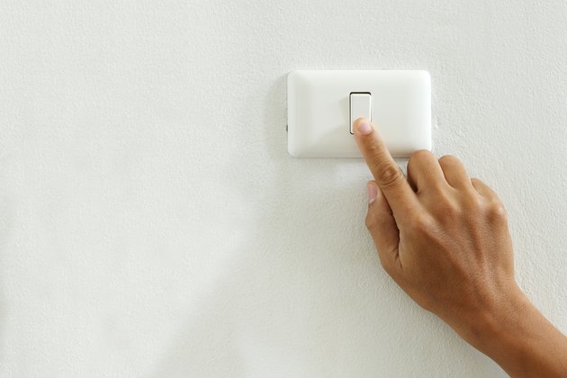 closeup of finger touching to electric switch off with copy space