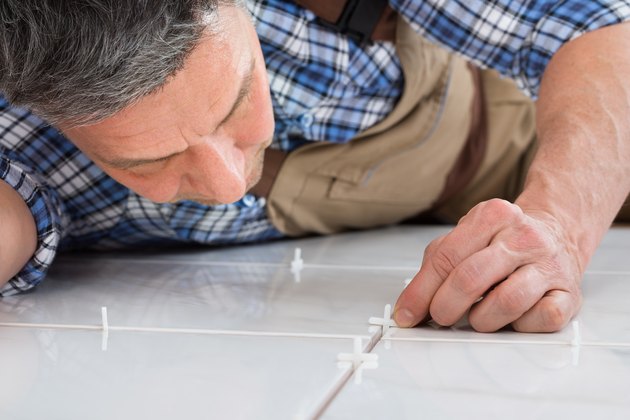 Handyman Placing Spacers Between Tiles