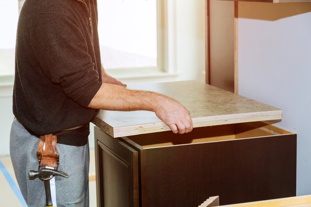 Contractor installing a new laminate kitchen counter top