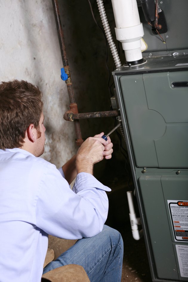 A service man working on a home furnace